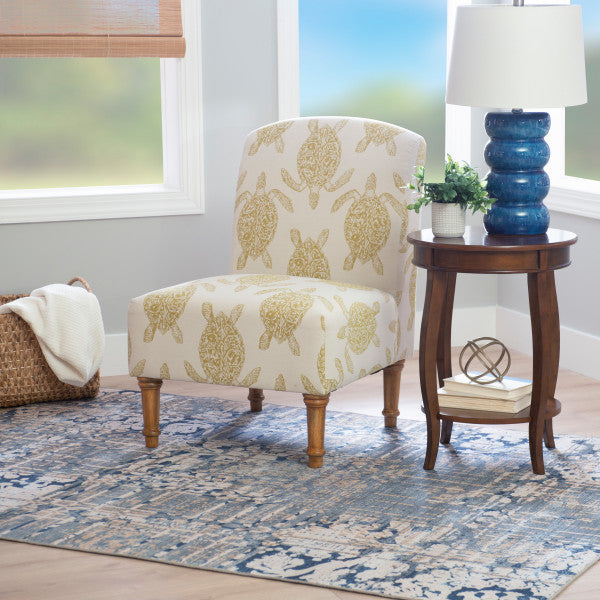 Three quarter front view armless accent chair cream fabric turtle pattern mustard yellow turned wooden legs styled living room