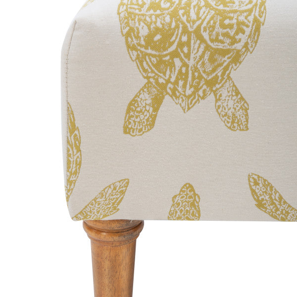 Zoomed in detail image cream fabric turtle patter in mustard yellow turned wooden leg white background