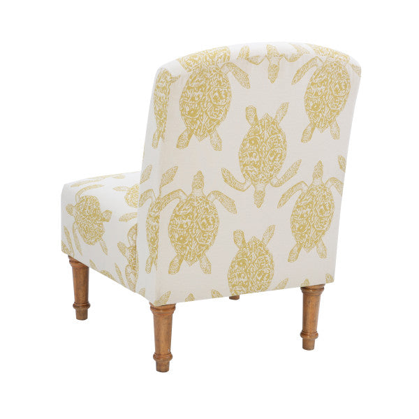 Three quarter back view armless accent chair cream fabric turtle pattern mustard yellow turned wooden legs white background