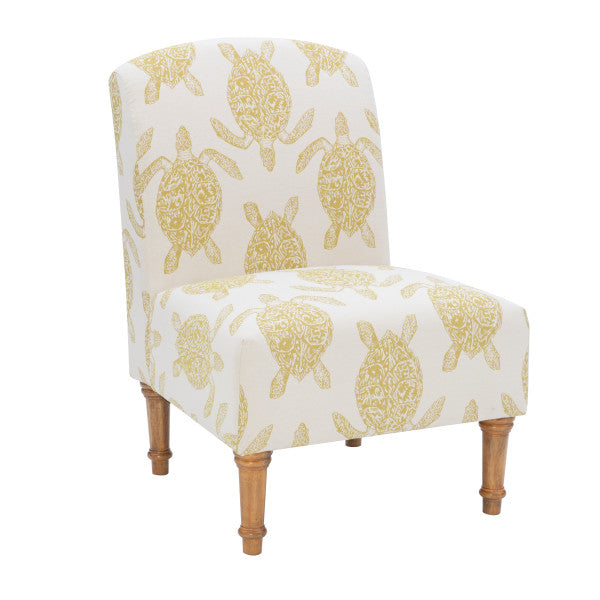 Three quarter front view armless accent chair cream fabric turtle pattern mustard yellow turned wooden legs white background